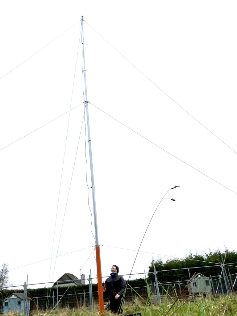 Paul Holly using an anemometer to measure wind speed and its potential impact on tree stability during the assessment.