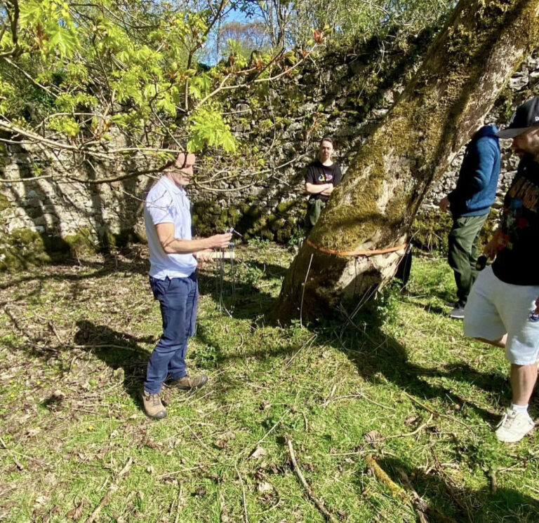 Paul Holly demonstrating tree risk assessment equipment during the Arborist Apprenticeship in Ireland training day with GRETB students outdoors.