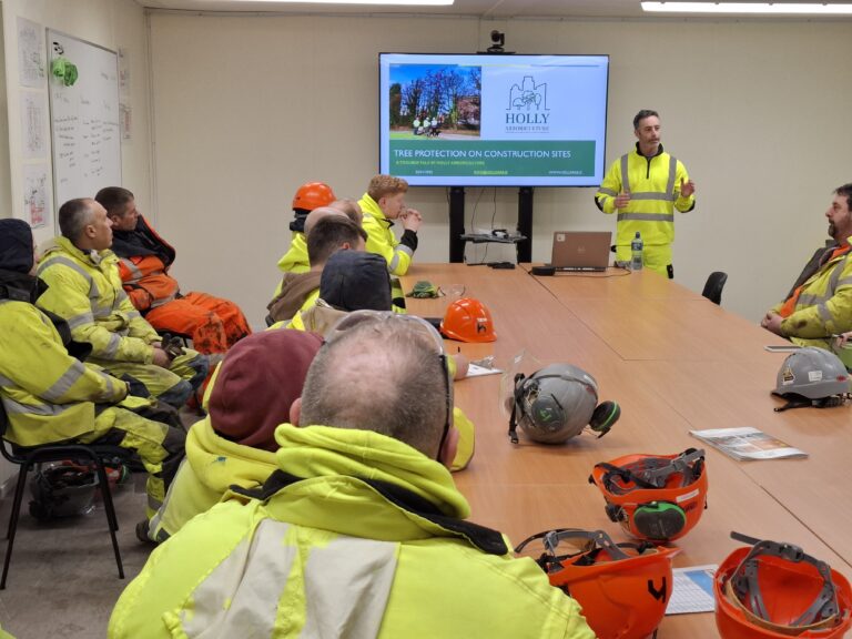 Project Arborist leading a toolbox talk training session for construction staff on tree protection measures in Cork.